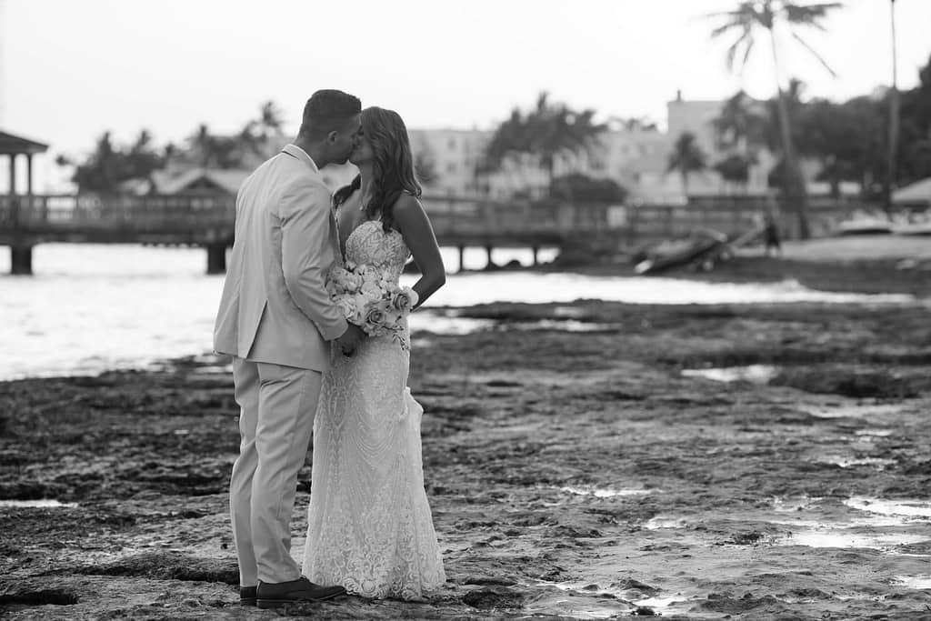 A Key West couple enjoys the sunset and photos while their wedding planner handles the reception details. 