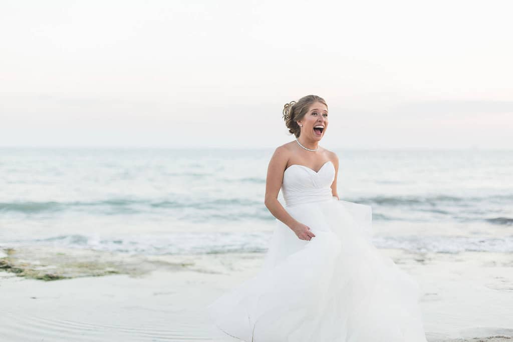 A bride laughs and relaxes as she enjoys her wedding day.