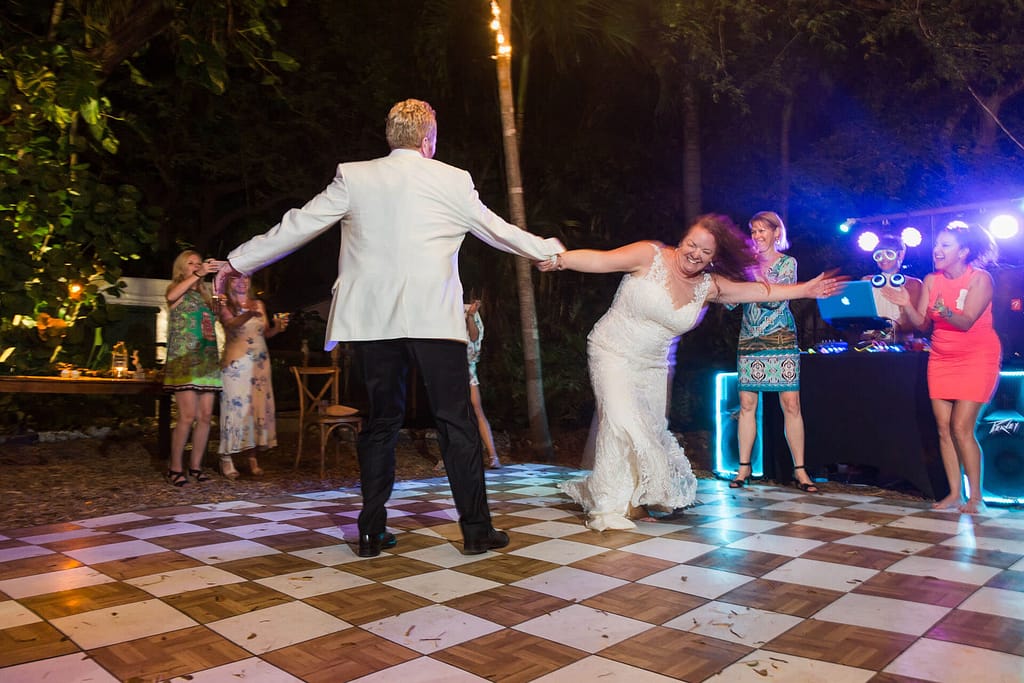 A newlywed couple has fun on the dance floor. 