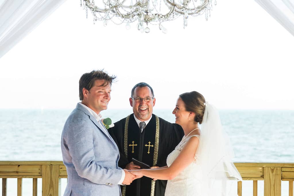 A couple laughs during their wedding ceremony at The Reach, in Key West