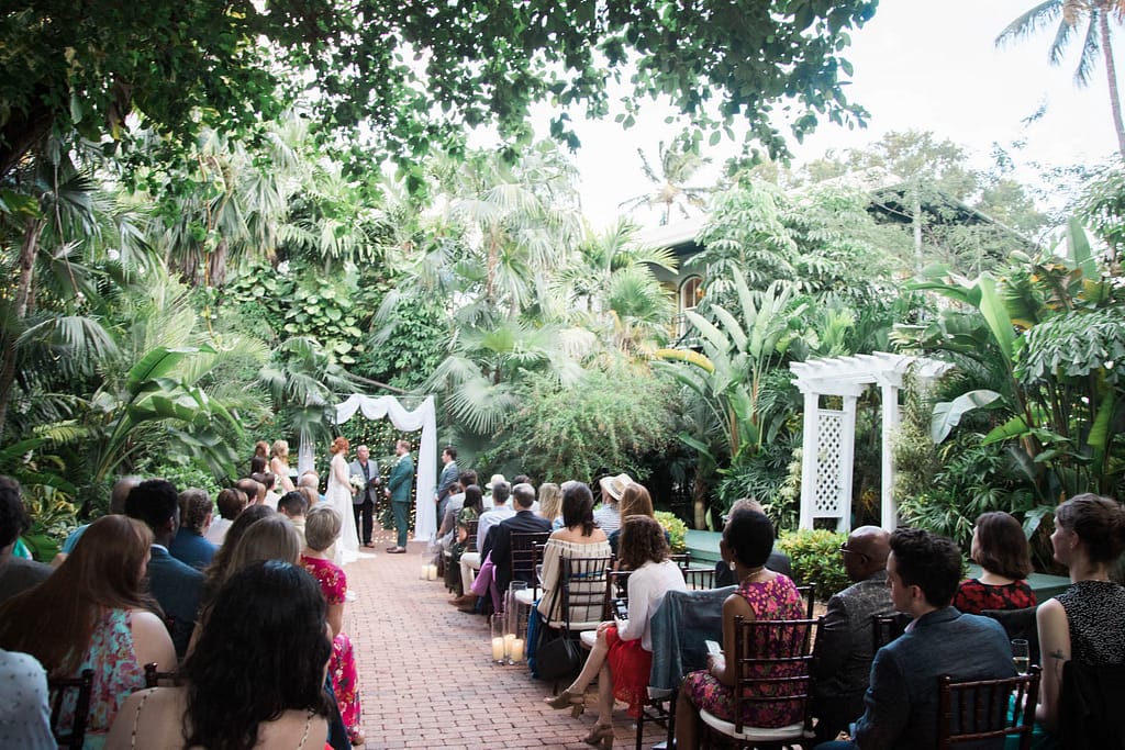 A wedding couple gets married at the Hemingway Home in Key West Florida.