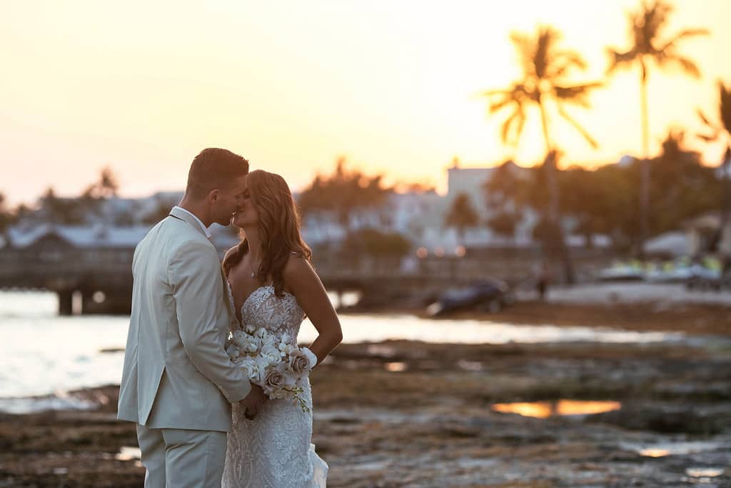 a couple kisses at sunset