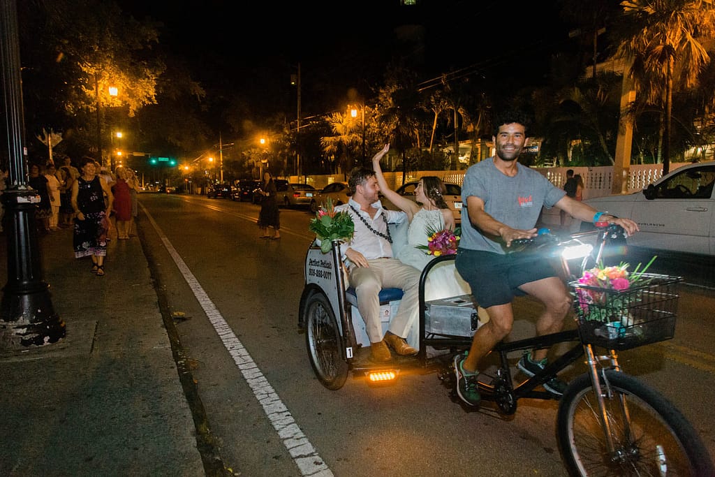 A couple takes a pedicab for their wedding day transportation in Key West.