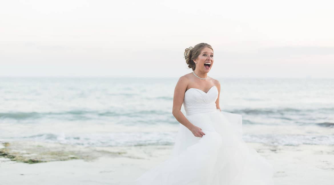 A bride laughs and relaxes as she enjoys her wedding day.