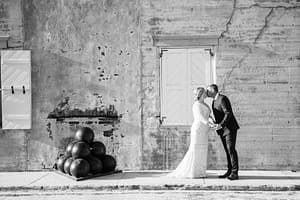 A couple kisses in front of the Fort Zachary Taylor walls.