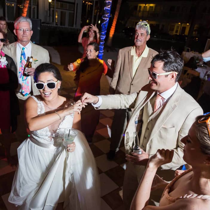 Couple dancing at wedding with sunglasses on.