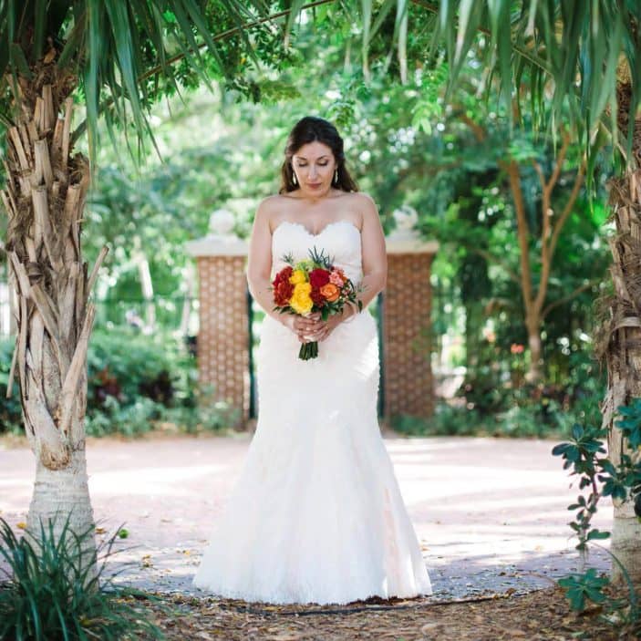 A beautiful portrait of a bride surrounded by palm trees.