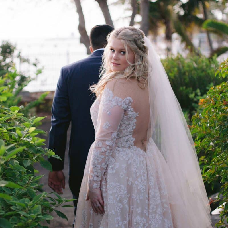 A bride showcases her stunning hair and makeup at her Key West wedding.
