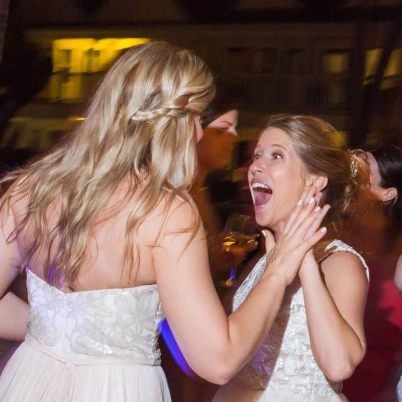bride and friend dance and laugh at a key west wedding